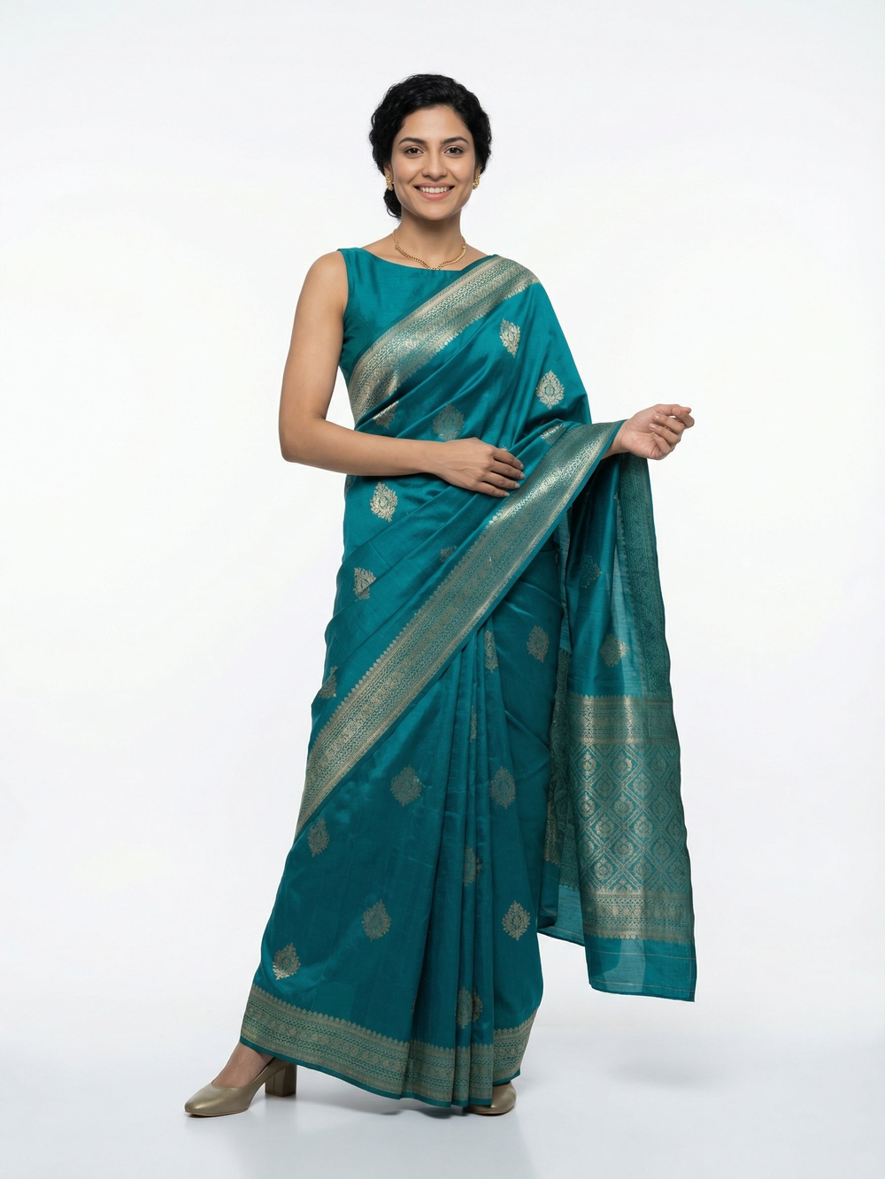 Woman wearing a teal saree with a white background