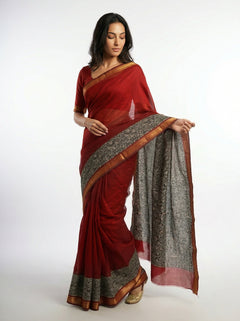 Woman wearing a red saree with a white background