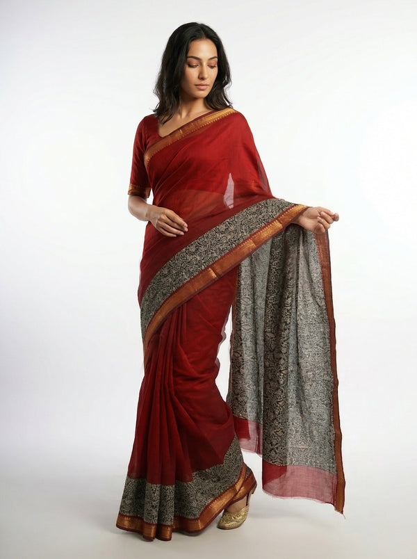 Woman wearing a red saree with a white background