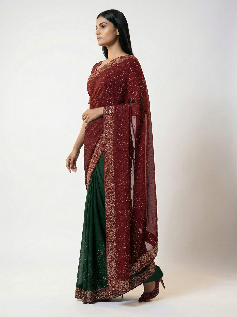 Woman in a traditional saree standing in a garden setting