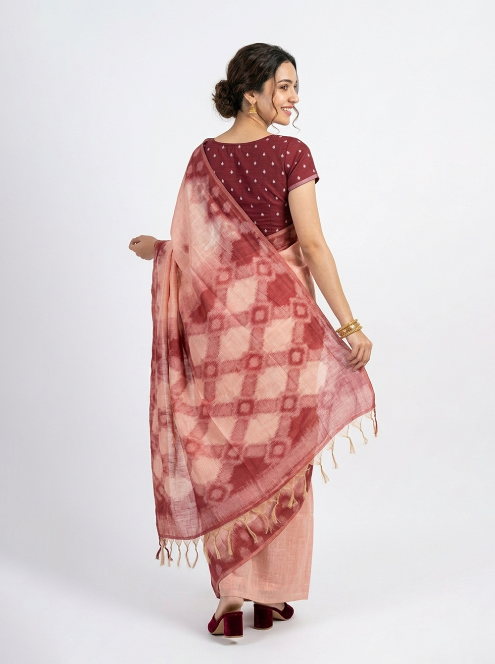 Woman wearing a traditional saree with a dark background