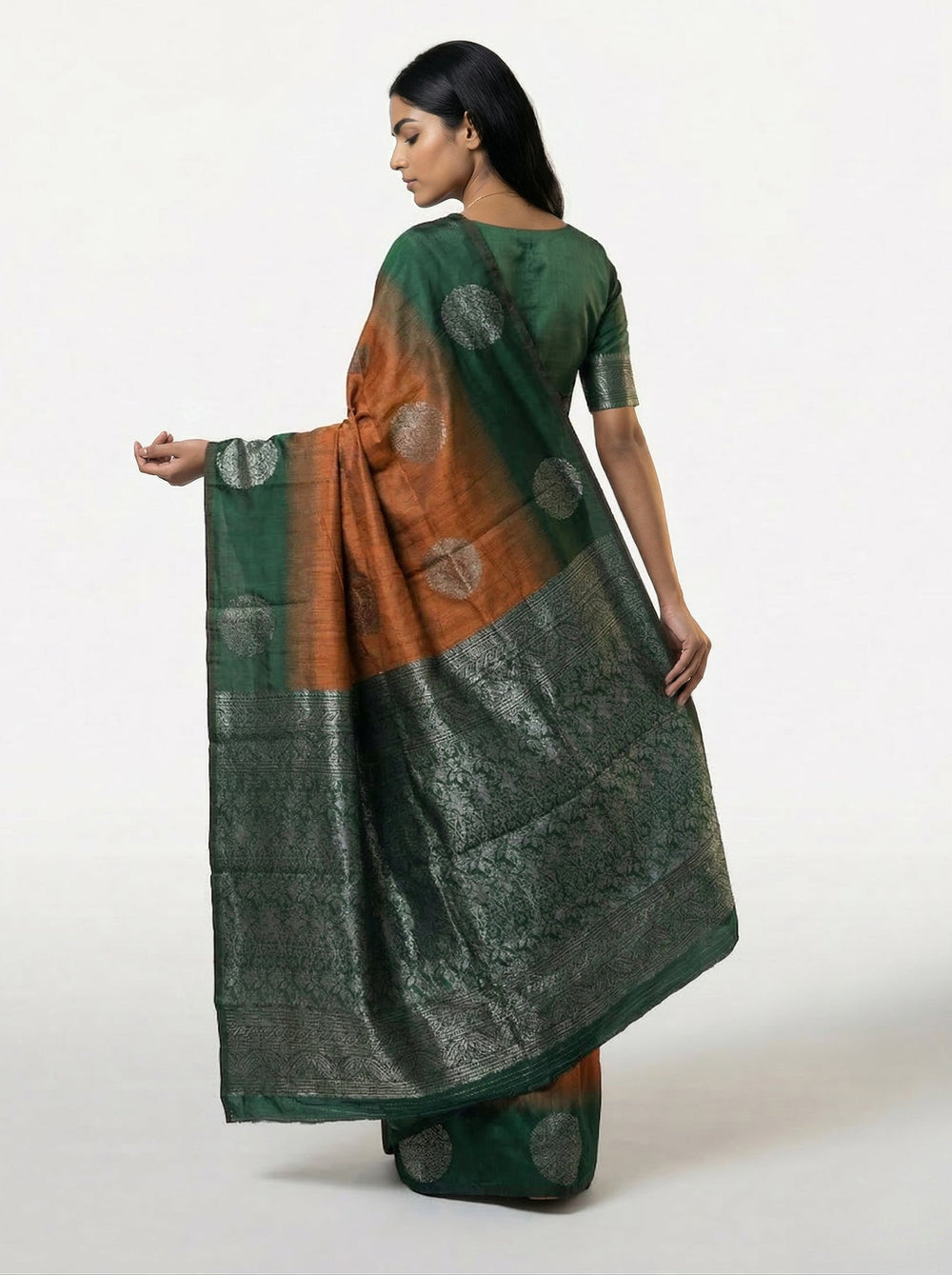 Woman wearing a brown and green saree against a yellow background