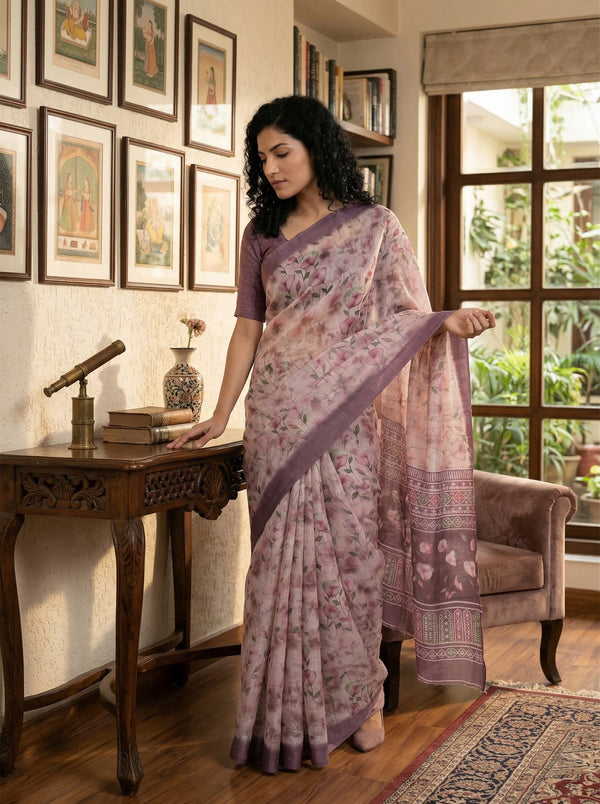 Woman in a floral saree standing in a room with decor elements.
