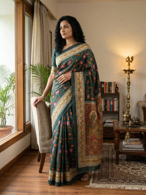 Woman in a traditional saree standing in a room with decor elements.