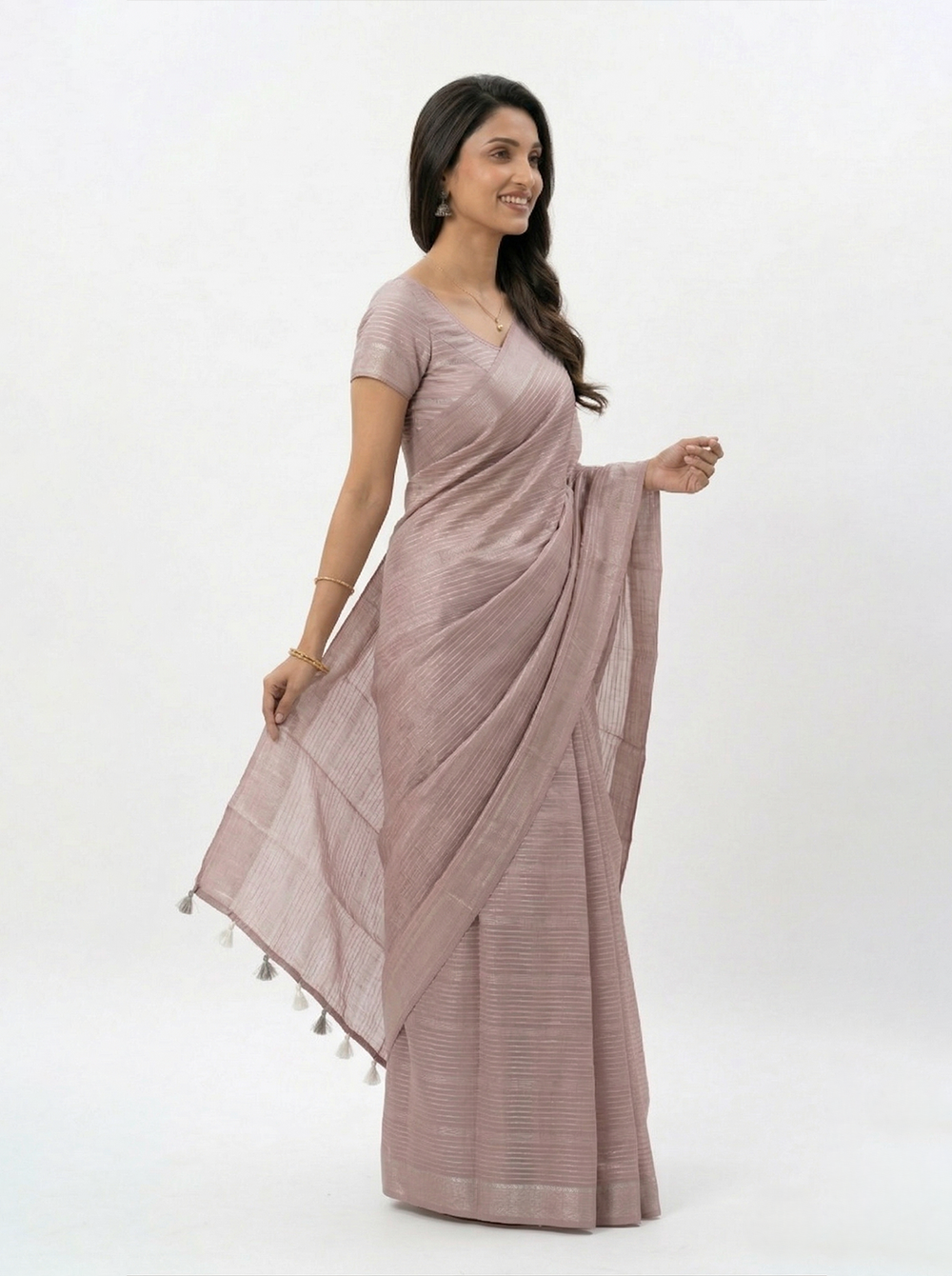 Woman wearing a mauve saree with a plain background