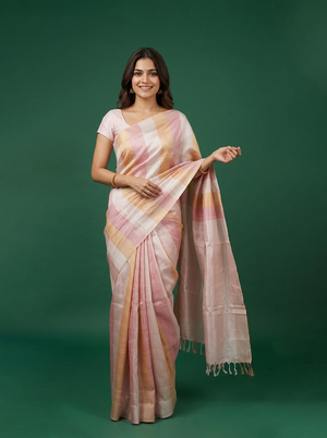 Woman wearing a pink and orange saree against a green background