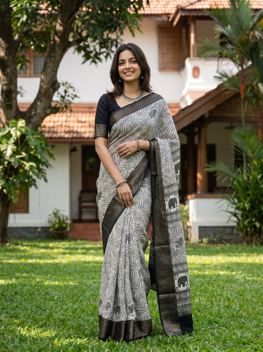 Woman wearing a traditional saree standing in a garden
