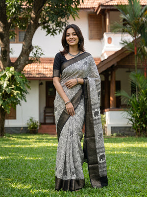 Woman wearing a traditional saree standing in a garden