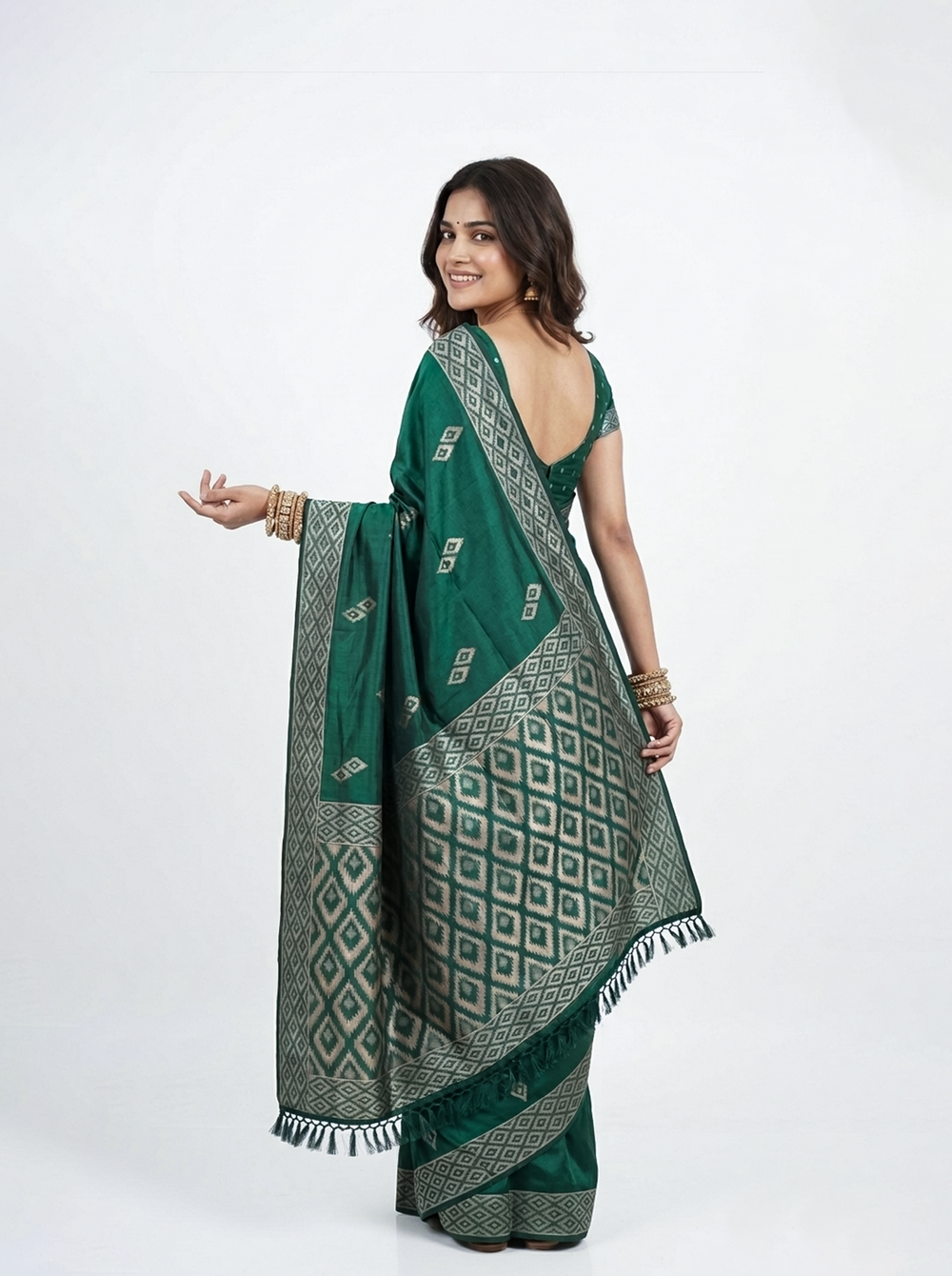 Woman wearing a green saree with a beige background