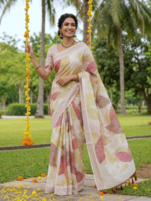 Woman in a floral saree standing outdoors with greenery in the background