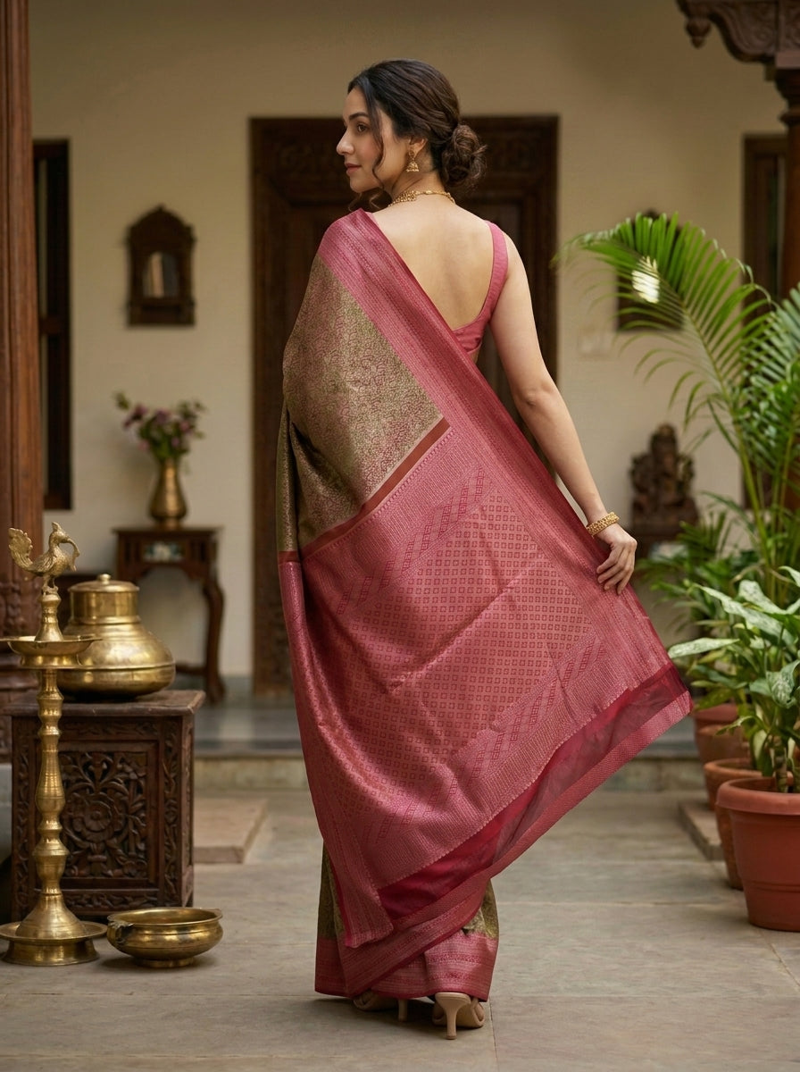 Woman wearing a traditional saree in a decorative setting with vases and plants.