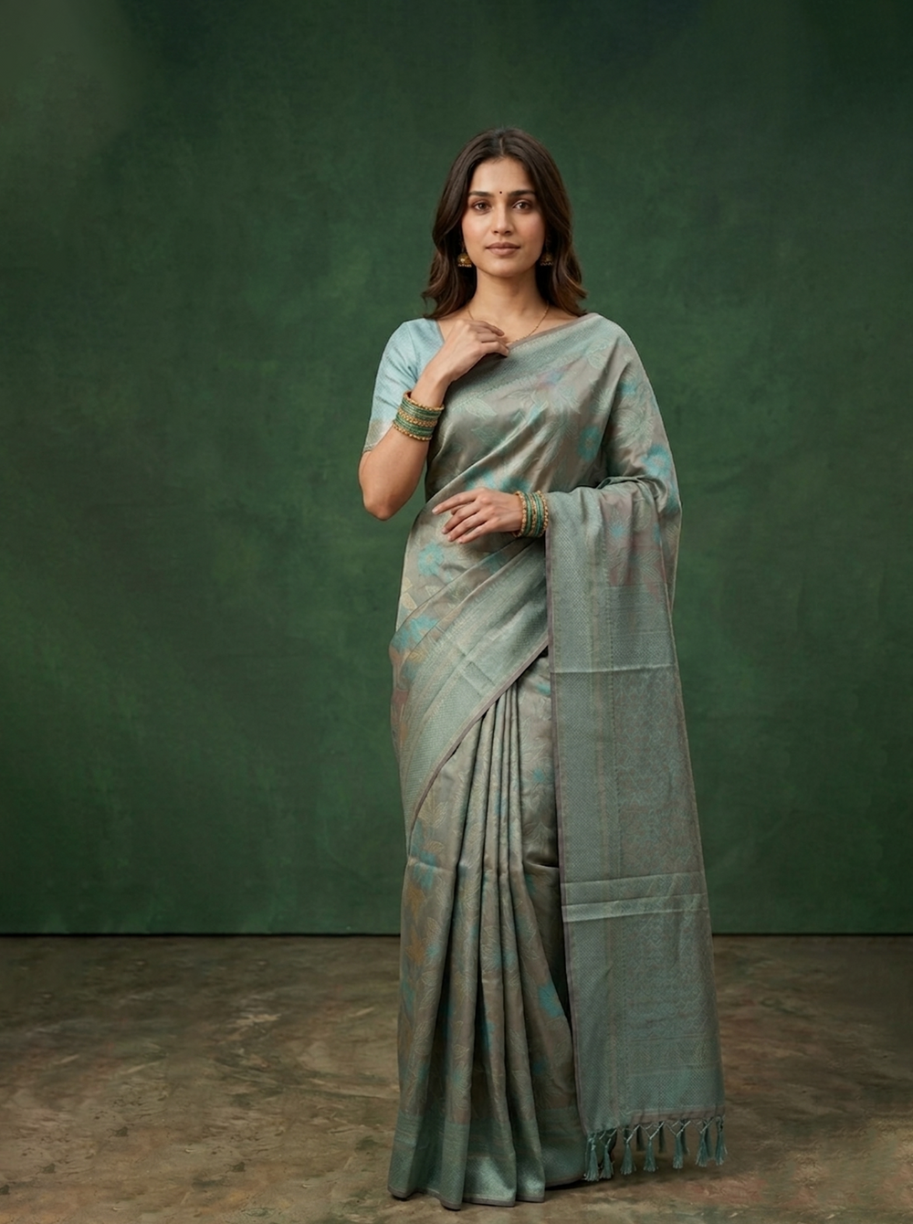 Woman wearing a traditional saree against a green background