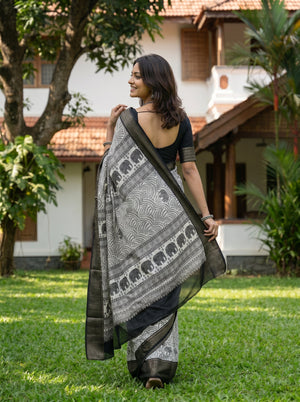 Synthetic Black White Elephant Motif Printed Saree with Traditional Woven Border