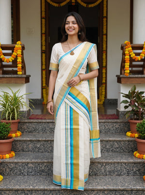 A woman wearing a cream-colored cotton saree with blue, yellow, and white stripes stands on stone steps in front of a doorway decorated with marigold garlands.
