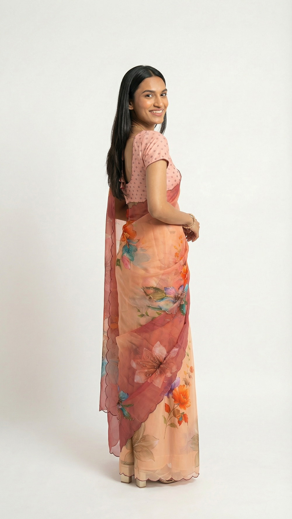 Woman wearing a floral saree with a green background