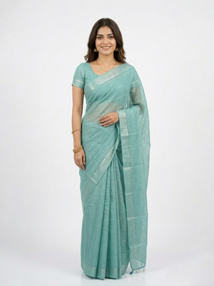 Woman wearing a light blue saree on a white background