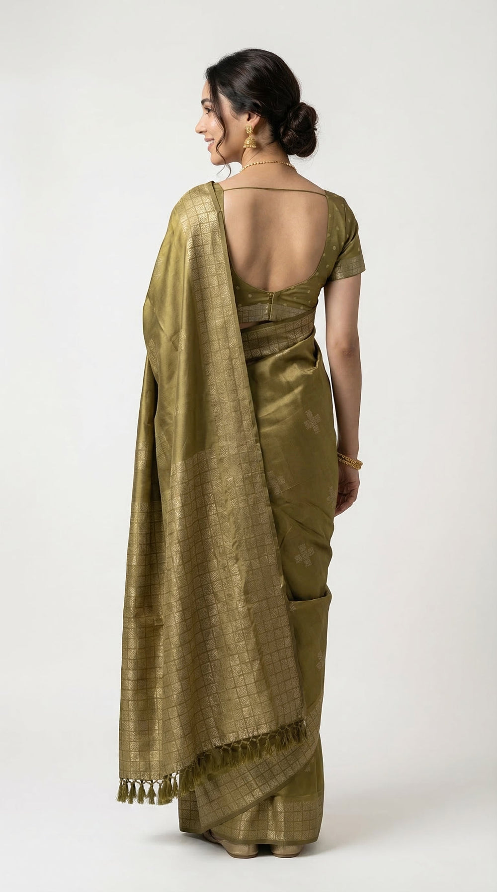 Woman wearing a green saree with a dark background