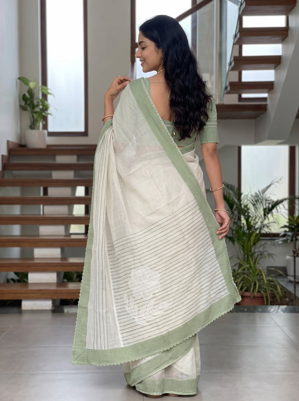 Net Kota Off White Saree with Green Line Pattern and Floral Motif Detail with Green Border Pallu