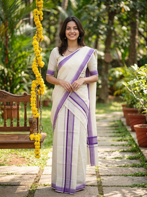 A woman wearing a white and purple saree stands on a stone path in a garden, with a wooden swing and yellow flower garlands visible on the left.
